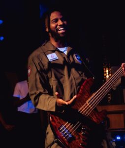 Harv playing bass guitar